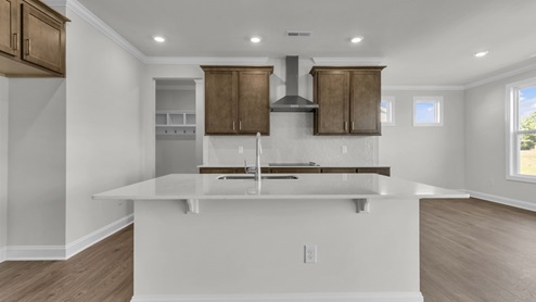 kitchen with brown cabinets and quartz countertops