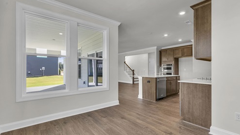kitchen with brown cabinets and quartz countertops
