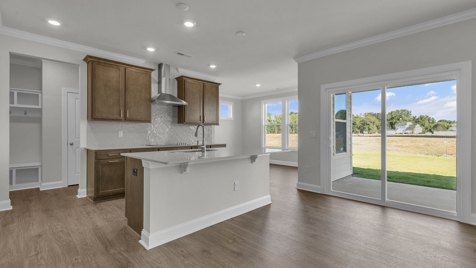 kitchen with brown cabinets and quartz countertops