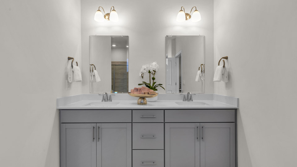 primary bathroom with dual vanity sinks