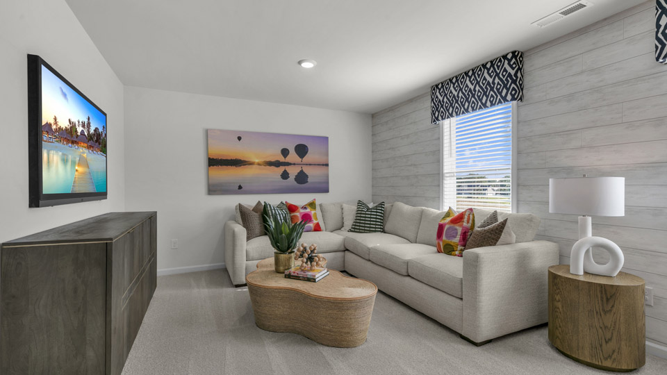 upstairs loft area with large windows and carpeting