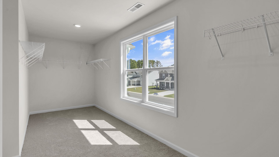 walk-in closet with wire shelving and window