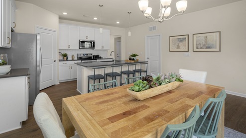 Living and dining area with ample lighting and revwood flooring