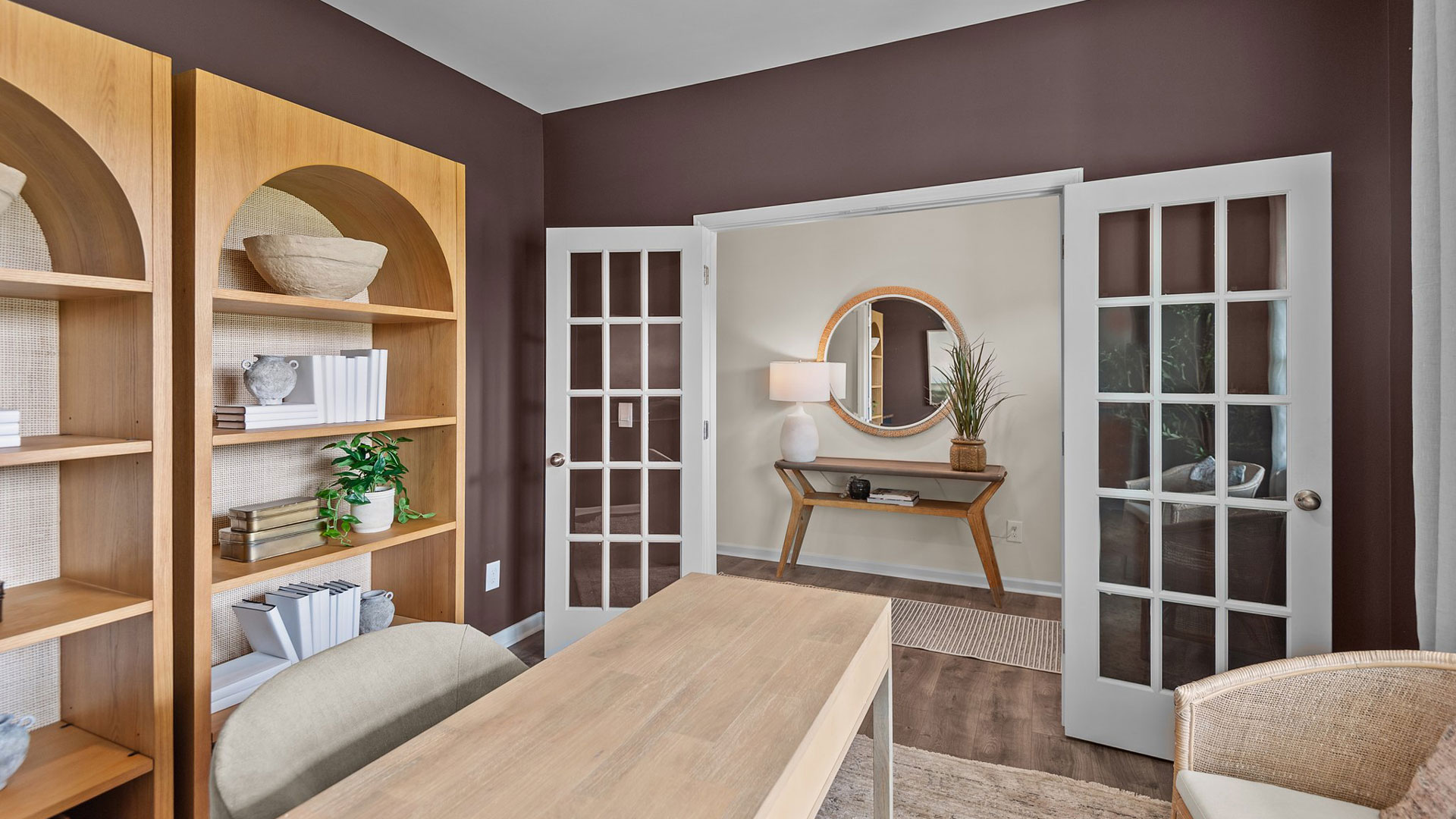 Study with ample lighting and revwood flooring and french doors