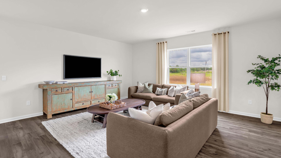 living area with ample lighting and revwood flooring