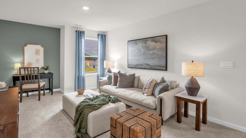 loft with natural lighting and carpet flooring