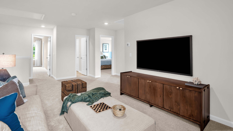 loft with natural lighting and carpet flooring