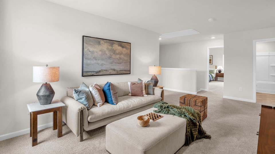 loft with natural lighting and carpet flooring