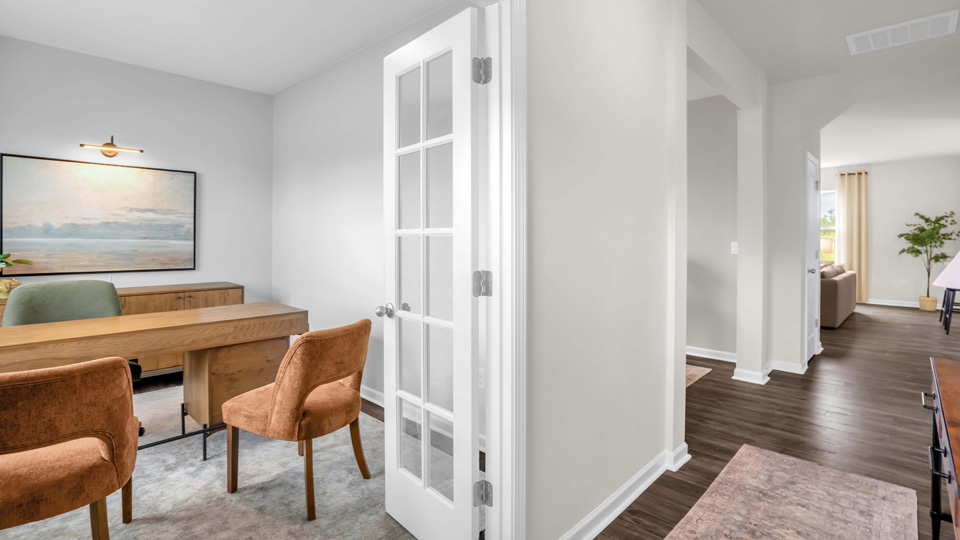 study with ample lighting and revwood flooring and french doors