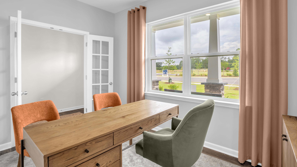 study with ample lighting and revwood flooring and french doors