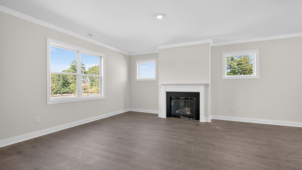 living room with revwood flooring and fireplace