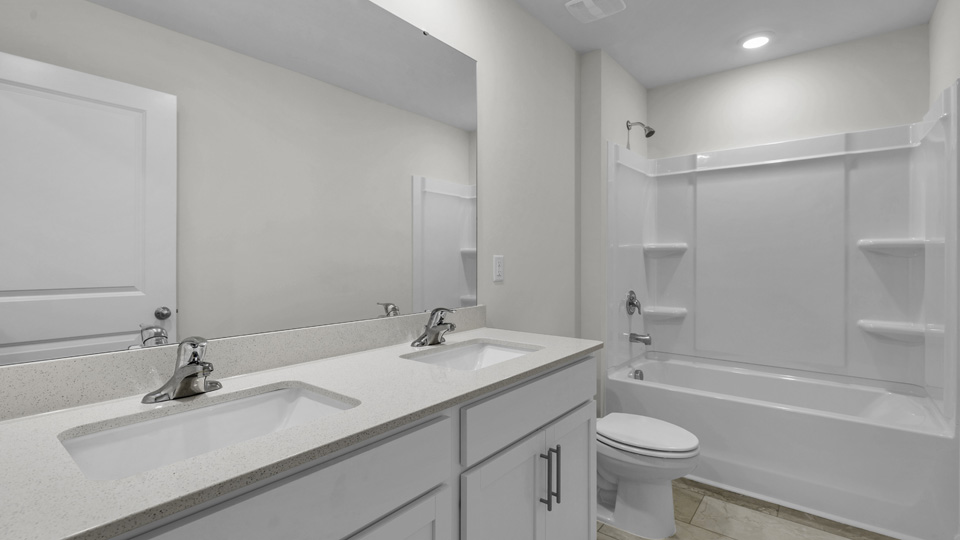 bathroom with white cabinets