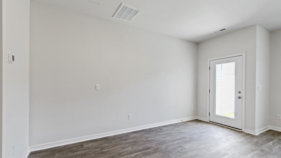 living and dining area with ample lighting and revwood flooring