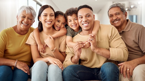 Multiracial Family Smiling on Couch
