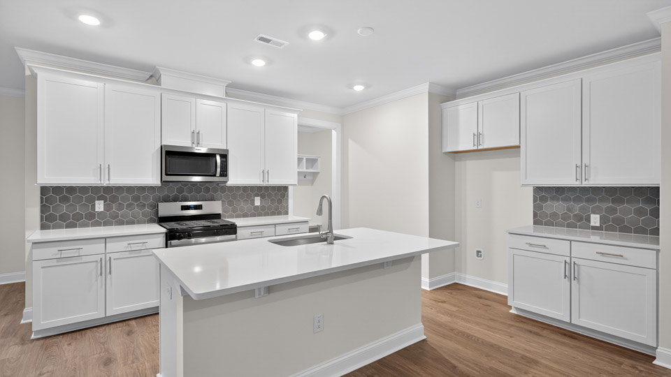 kitchen with white cabinets quartz countertops and stainless steel appliances