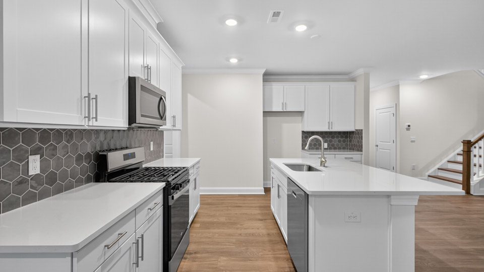kitchen with white cabinets quartz countertops and stainless steel appliances