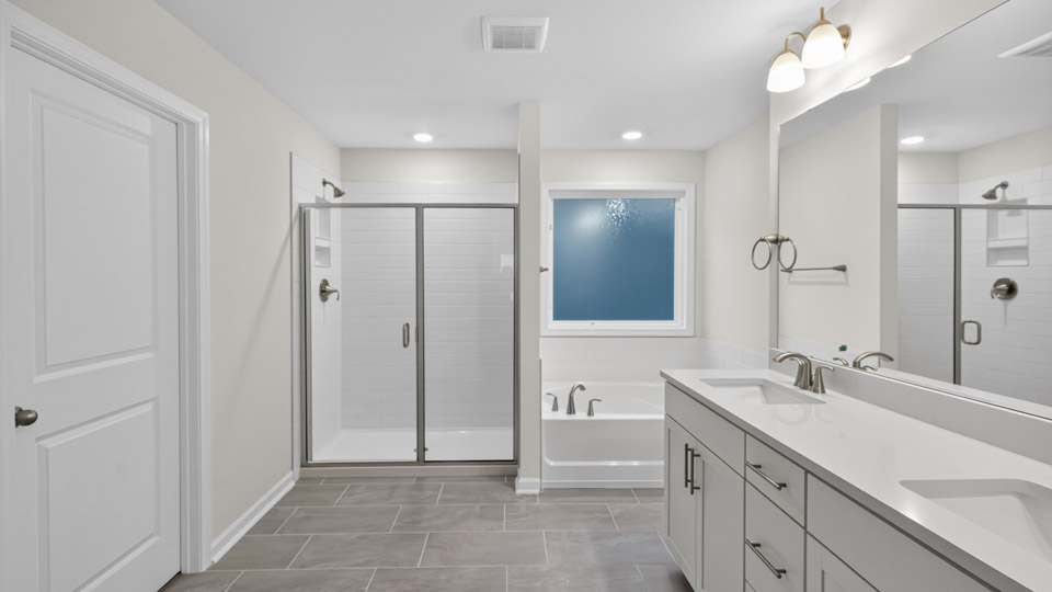 bathroom with separate tub and walk-in shower and quartz countertops