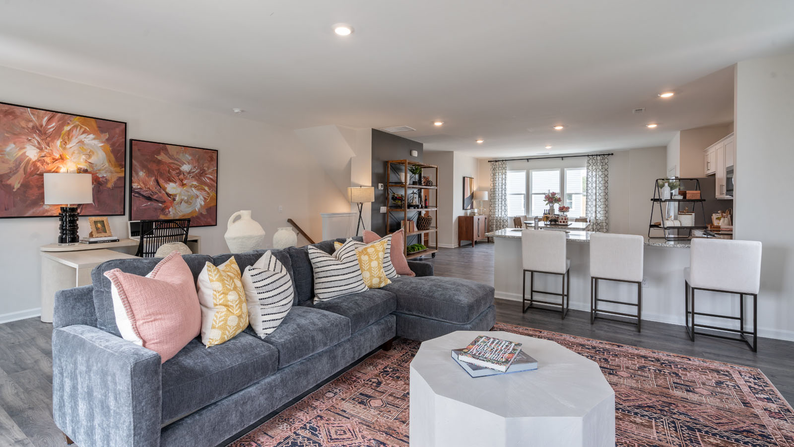 Living area with ample lighting and revwood flooring