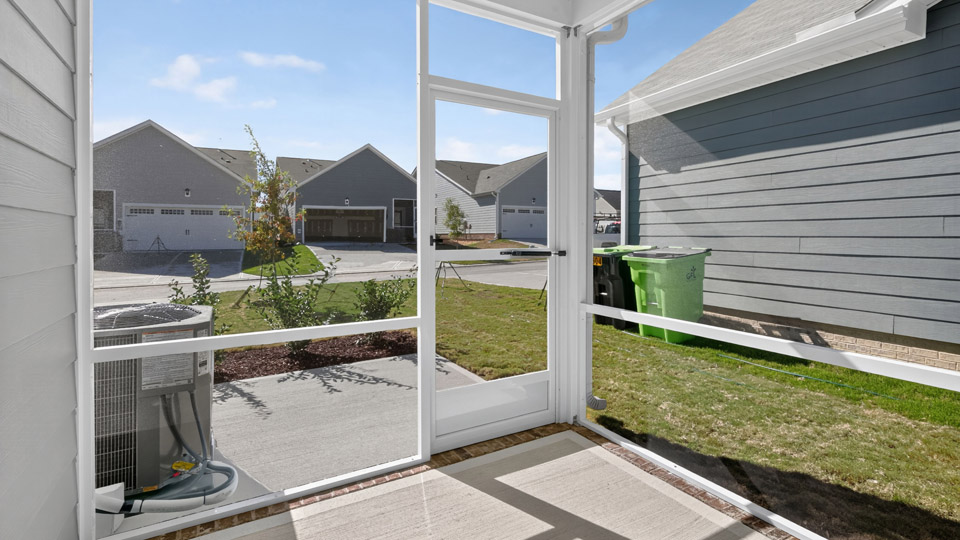 covered and screened-in back patio