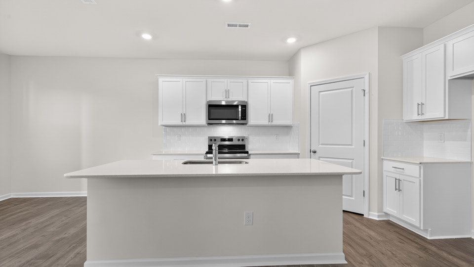 kitchen with white cabinets quartz countertops and stainless steel appliances