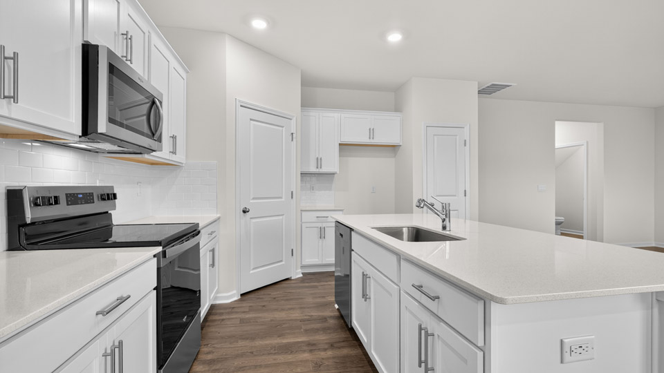 kitchen with white cabinets quartz countertops and stainless steel appliances