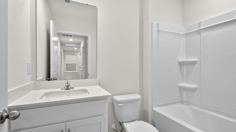 bathroom with quartz countertops and tub shower combo