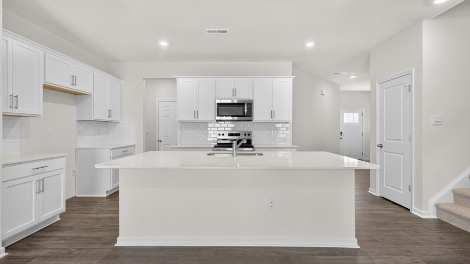 kitchen with white cabinets quartz countertops and stainless steel appliances