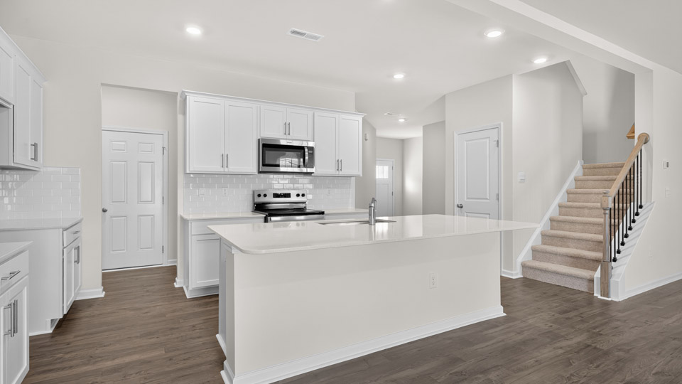 kitchen with white cabinets quartz countertops and stainless steel appliances