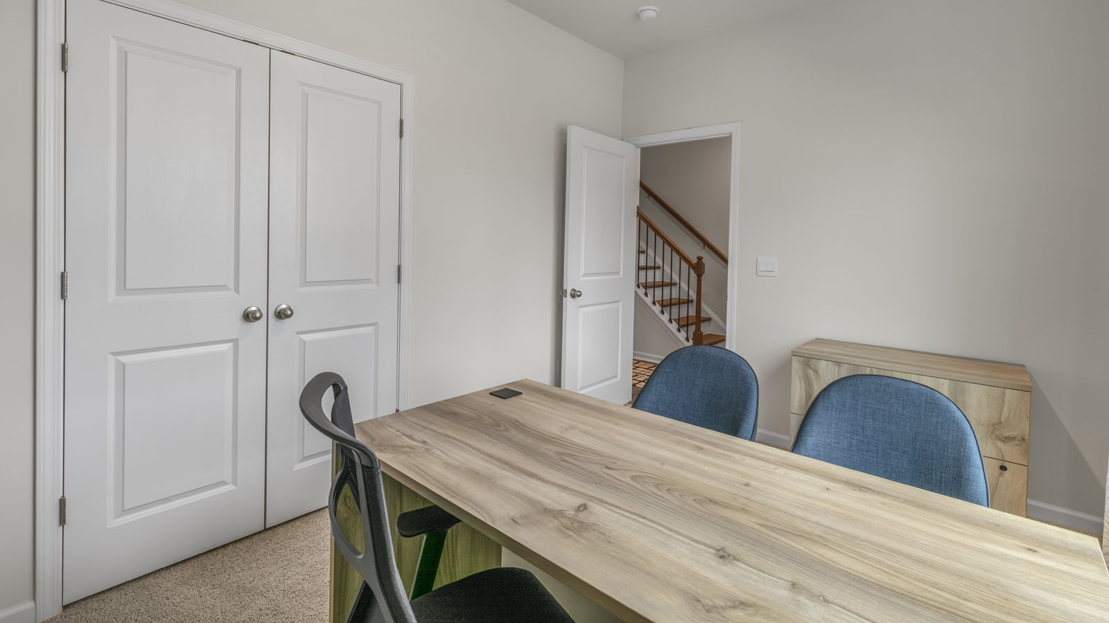 Study with carpet flooring and ample lighting