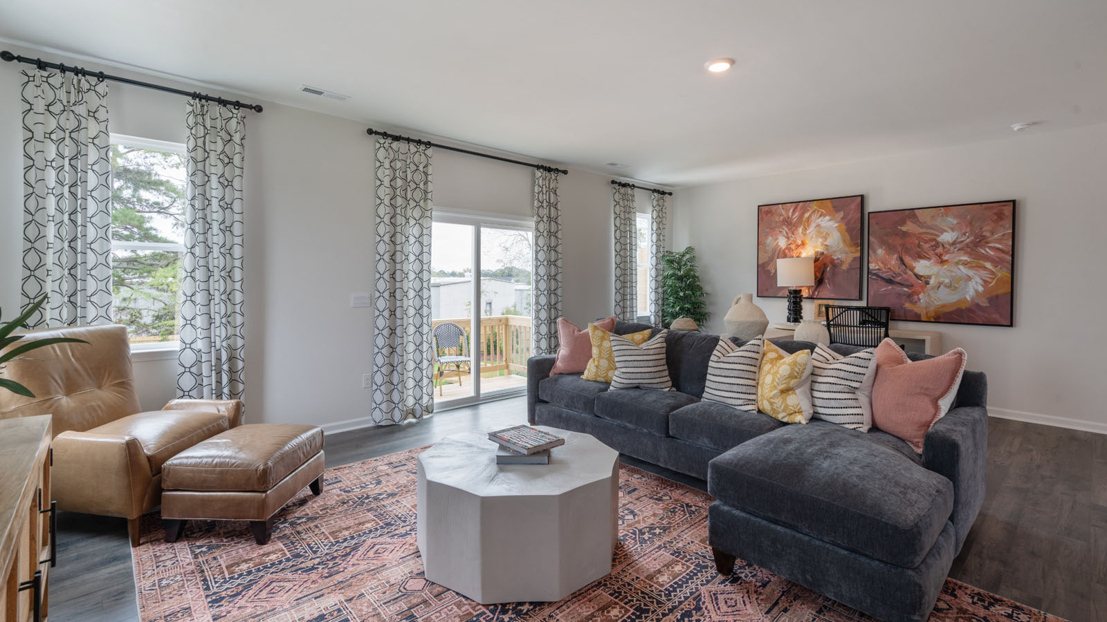 Living area with ample lighting and revwood flooring