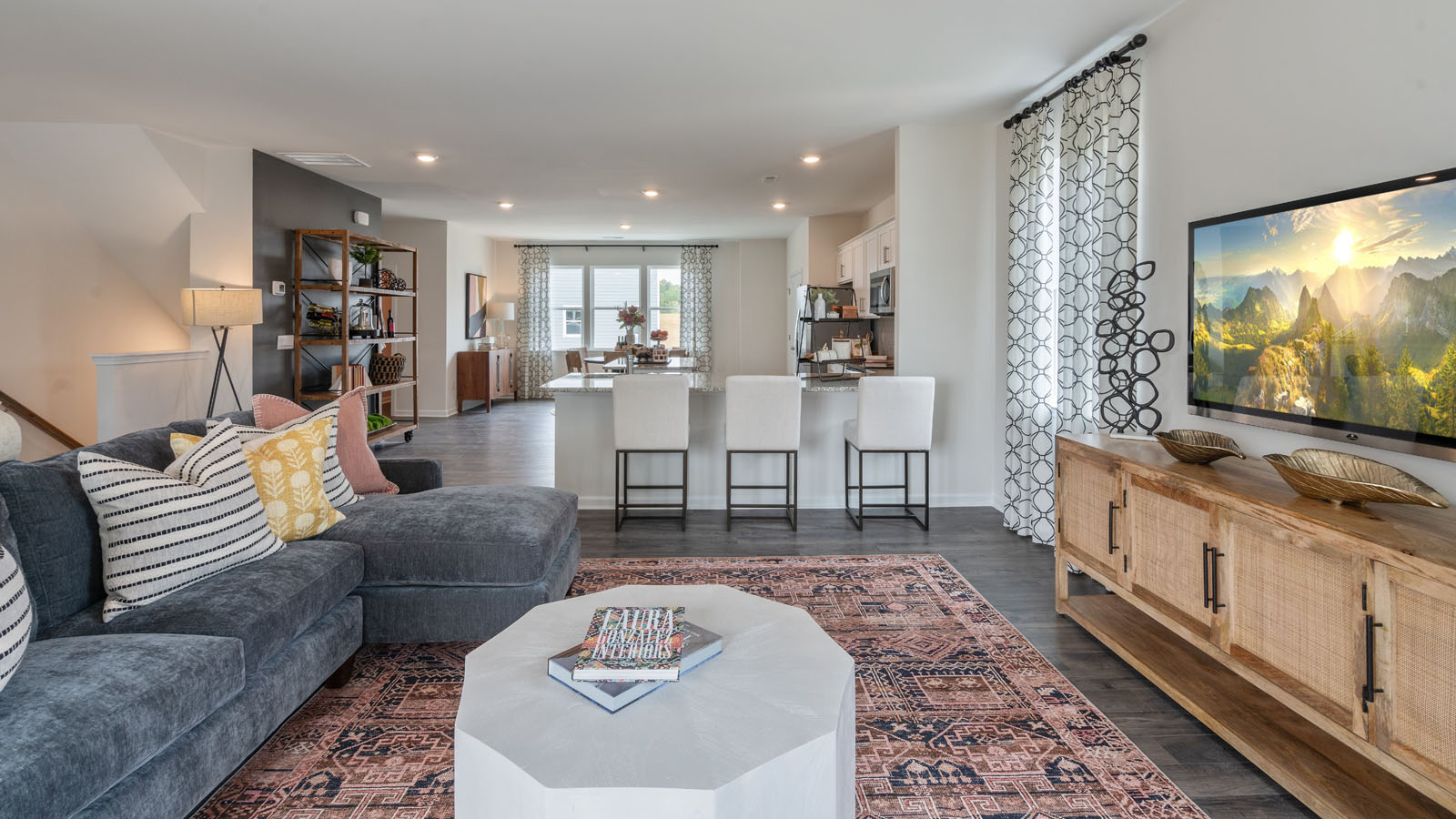 Living area with ample lighting and revwood flooring
