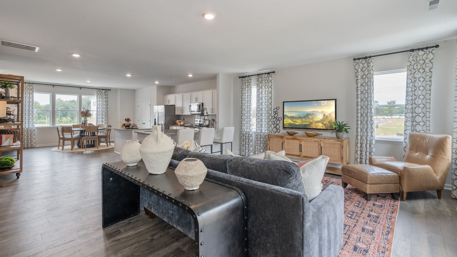 Living area with ample lighting and revwood flooring