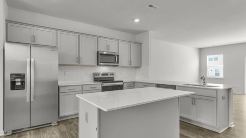 Kitchen with quartz countertops and stainless steel appliances