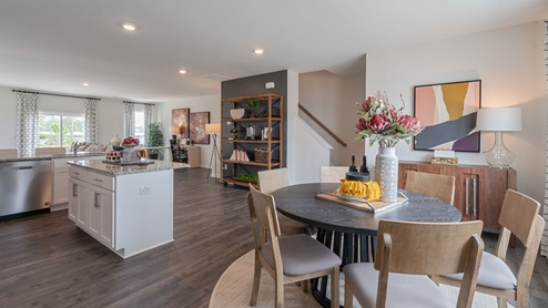Dining area with ample lighting and revwood flooring