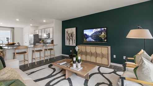 Living area with ample lighting and revwood flooring