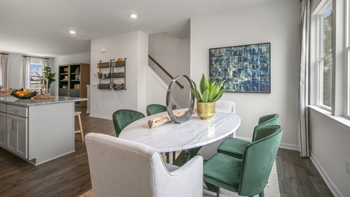 Dining area with ample lighting and revwood flooring