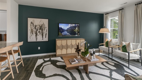 Living area with ample lighting and revwood flooring