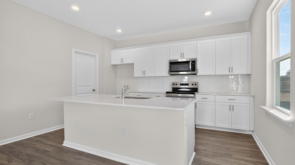 kitchen with white cabinets quartz countertops and stainless steel appliances
