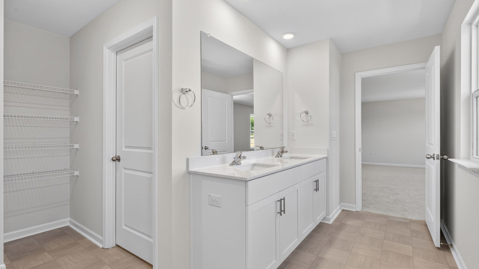 bathroom with quartz countertops and white cabinets