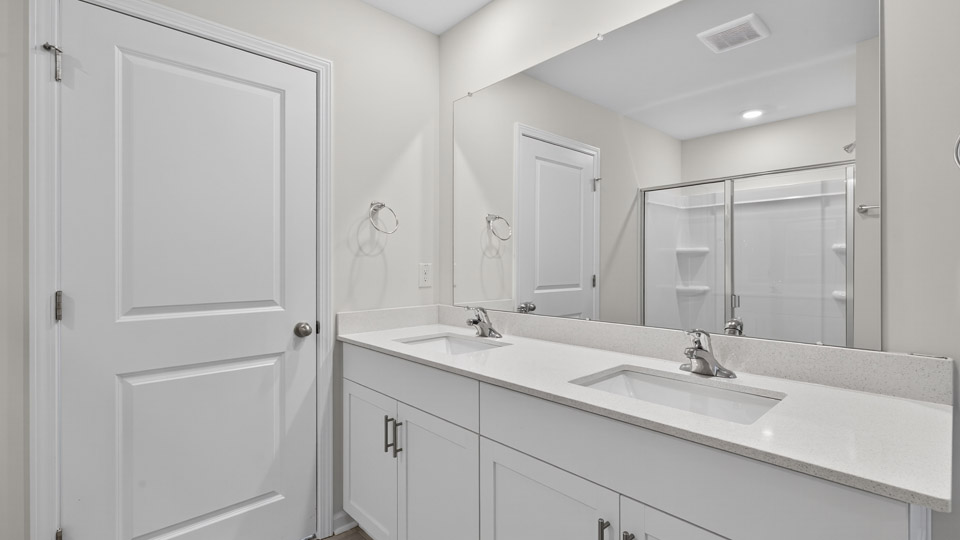 bathroom with quartz countertops and white cabinets