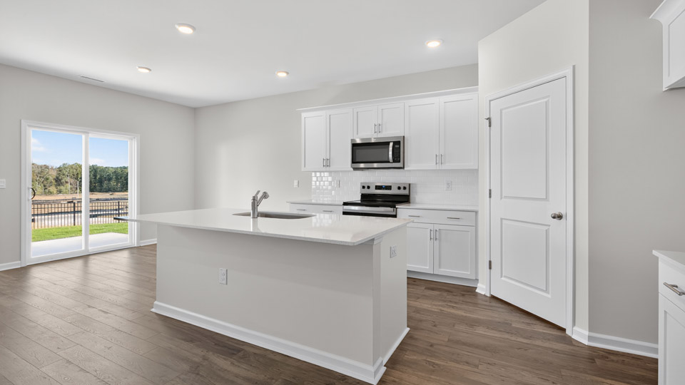 kitchen with island white cabinets quartz countertops and stainless steel appliances