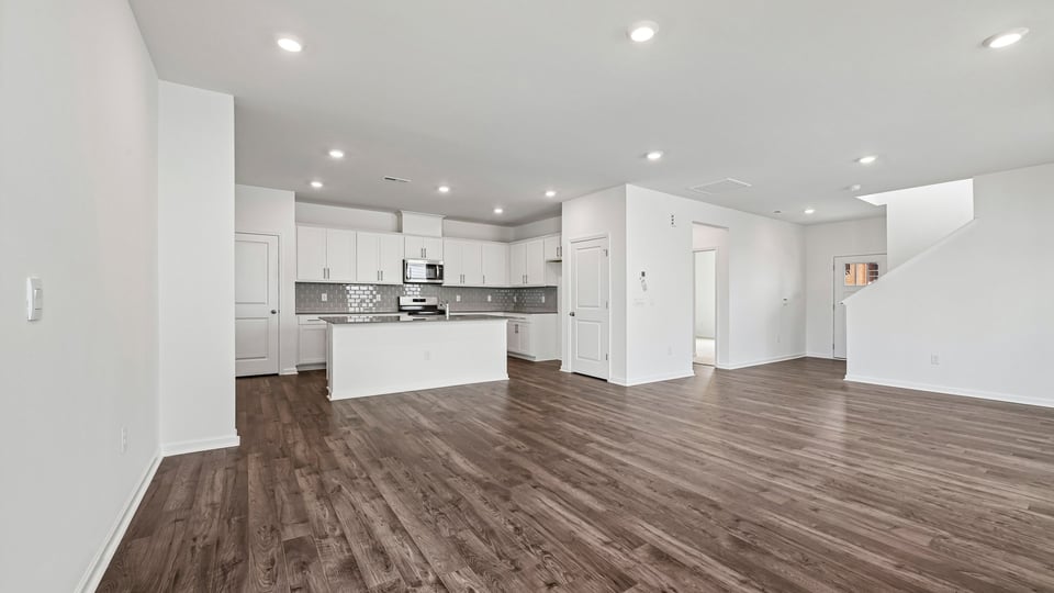 open concept living area overlooked by kitchen