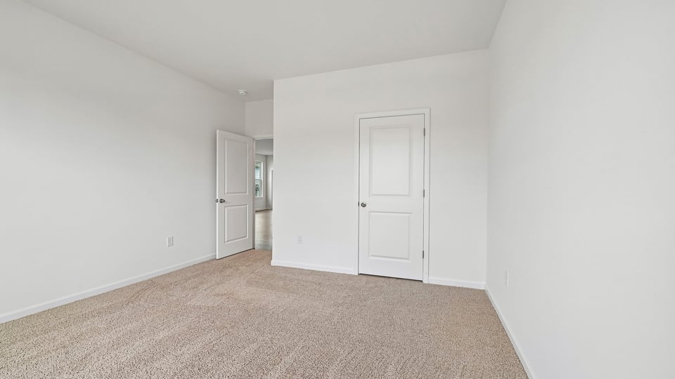 secondary bedroom with carpet flooring