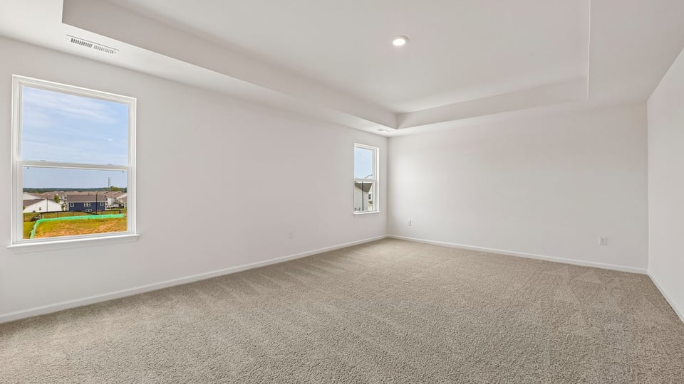 primary bedroom with tray ceiling