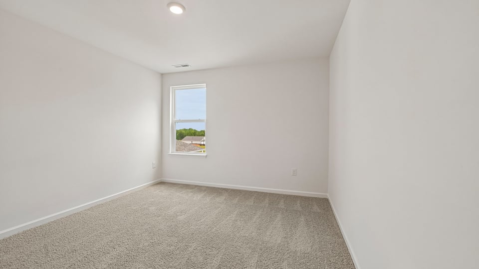 secondary bedroom with carpet flooring