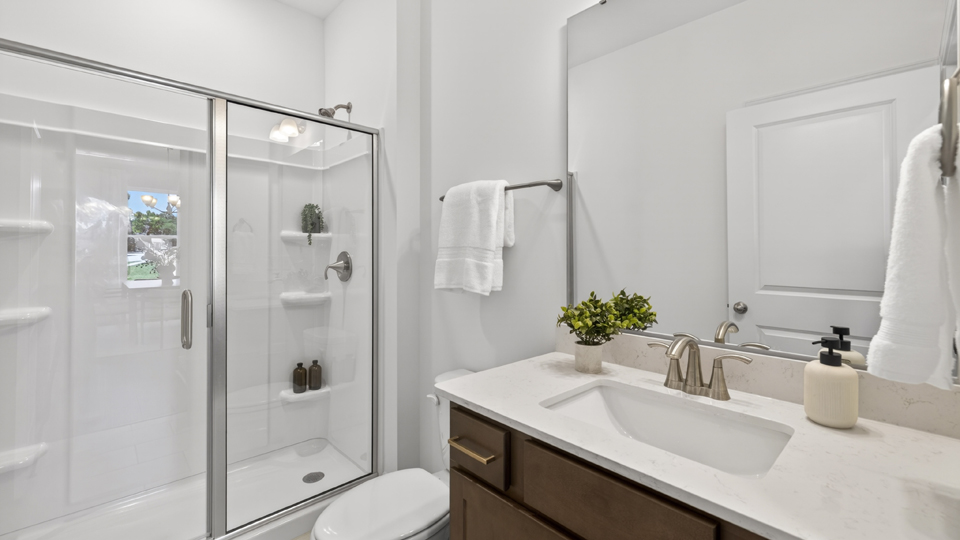 bathroom with walkin shower and quartz countertops