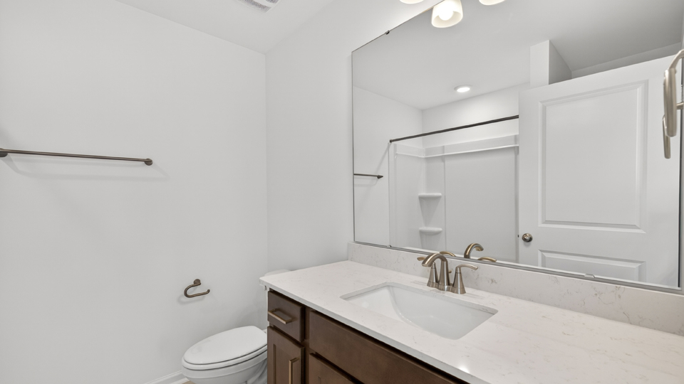 bathroom with tub shower combo and quartz countertops