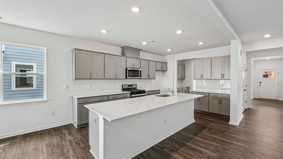 kitchen with large island gray cabinets and quartz countertops