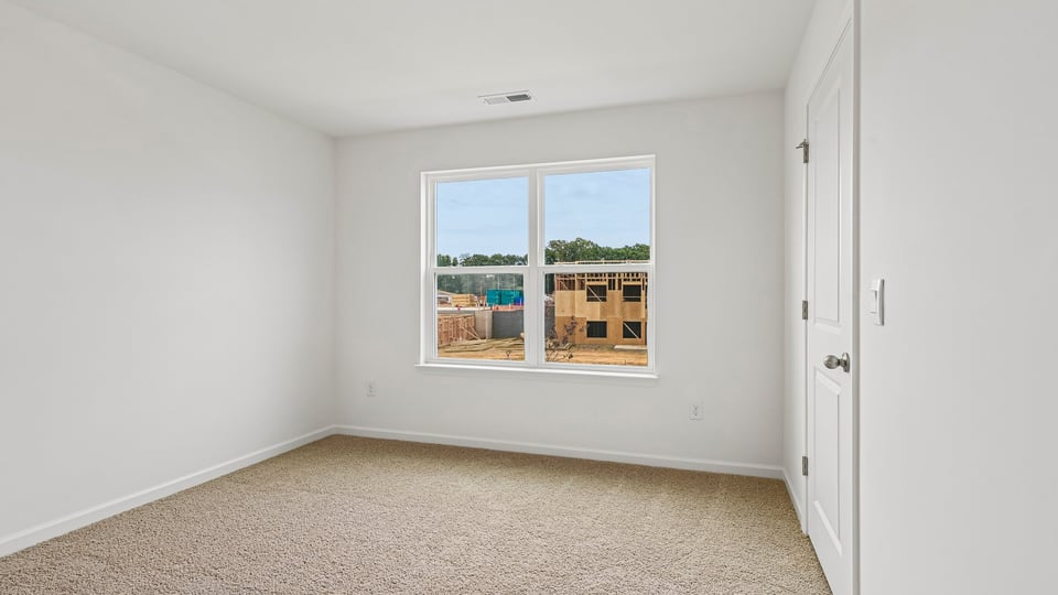 secondary bedroom with carpet flooring
