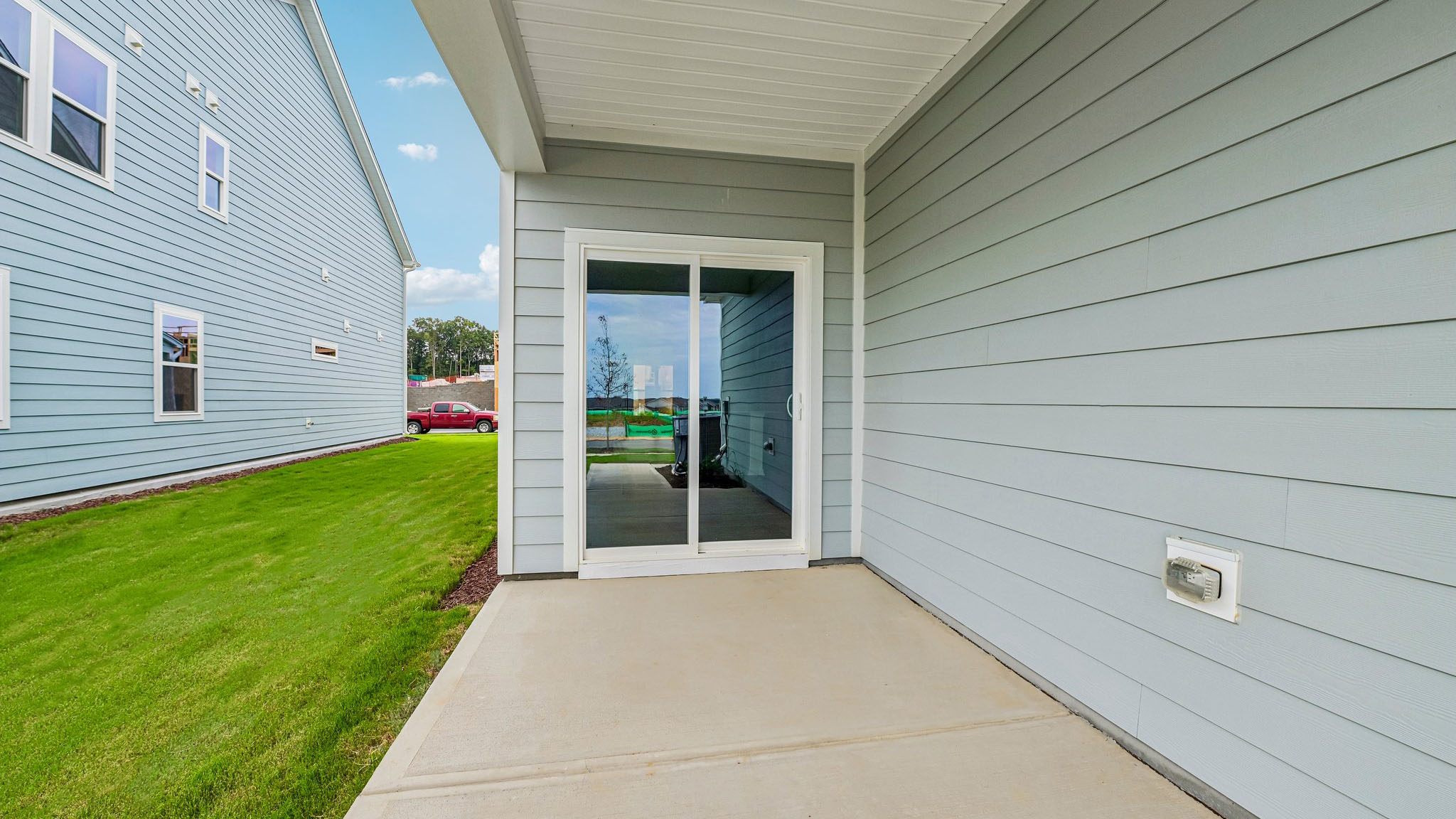covered patio with sliding glass doors